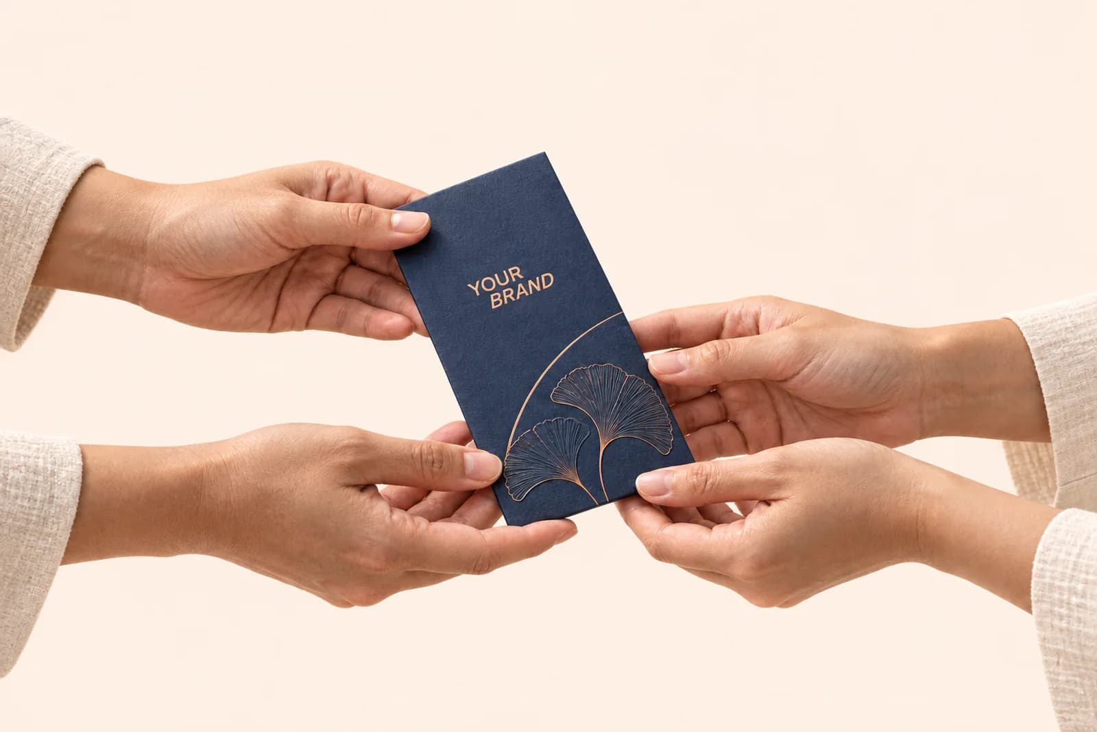 One pair of hands passing a navy money packet foil stamped with the Gifthxs mark to another pair of hands