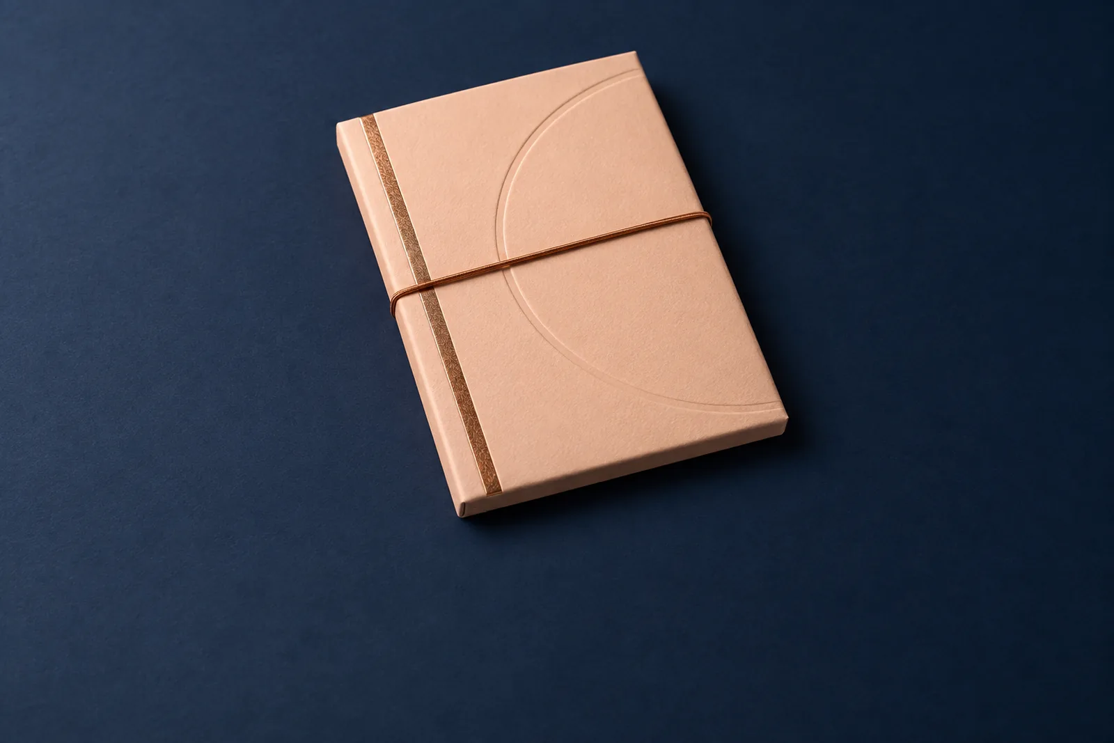 A premium presentation folder for money packets with a copper foil rule and cord closure